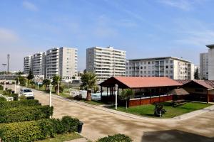 a street with a building and tall buildings at Cabañas Rey Pacific in La Serena