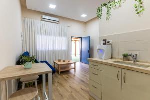 a kitchen with a table and a counter top at Fata morgana Hostel in Beer Sheva