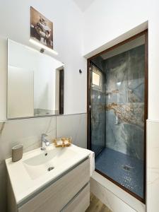 a bathroom with a sink and a shower at Tina House in Siculiana