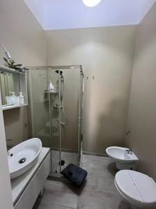 a bathroom with a shower and a toilet and a sink at Radici Mare B&B in Torre dell'Orso +41 photos