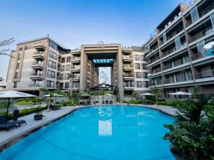 a large swimming pool in front of some apartment buildings at The Avery Studio at Diamond ITC in Accra