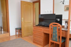 Televízia a/alebo spoločenská miestnosť v ubytovaní Panoráma Apartmanház
