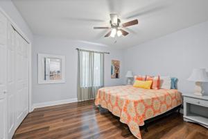 a bedroom with a bed and a ceiling fan at Peaceful Fairhope Retreat-Large home on 1 acre lot in Fairhope