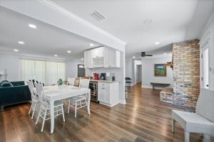 a kitchen and living room with a white table and chairs at Peaceful Fairhope Retreat-Large home on 1 acre lot in Fairhope