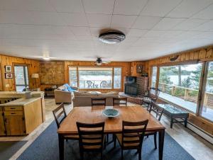 a living room with a wooden table and chairs at Frenchman Bay Oceanfront Getaway in Sullivan