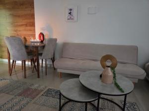 a living room with a couch and a table at צימר ליאלינא in Ein Kinya +6 photos