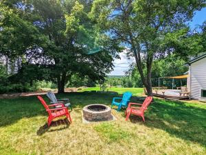 four chairs sitting around a fire pit in a yard at Bayside Waterview Cottage in Ellsworth