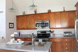 a kitchen with a sink and a microwave at Couples Cove Cottage in Ellsworth