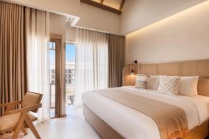 a bedroom with a large bed and a large window at PE-LA Thapae Boutique Hotel in Chiang Mai