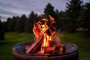 a fire in a grill in a field at Seaside Spindle Cottage in Ellsworth