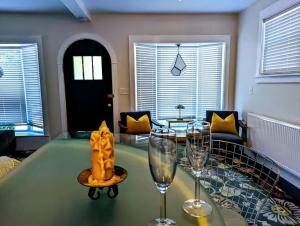 a living room with a glass table and two wine glasses at Acadia Park Suites 1 in Southwest Harbor