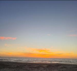 a sunset on a beach with the ocean at Albanian Dream Escape Apartment in Golem