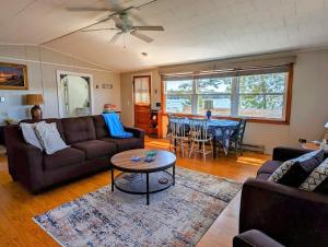 a living room with a couch and a table at Lobster Pound Beach House in Hancock