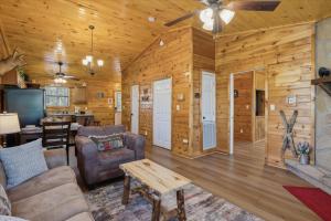 a living room with a couch and a table at A Dream Romance Cabin With Hot Tub & Fireplace in Sevierville