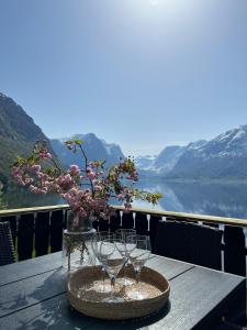 a table with wine glasses on a table with a view at Flo Lake House in Stryn