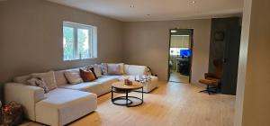 a living room with a couch and a table at Beautifull house with 7 bedrooms in Sandefjord