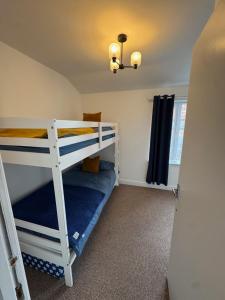 a bedroom with two bunk beds in a room at Valletta House Holiday Apartments in Skegness