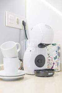 a kitchen counter with a coffee maker and cups at Villa Perla de Pilar - Private pool and rooftop near Beach - by Oyoostays in Pilar de la Horadada