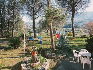 a garden with chairs and tables and a table and chairs at Parco dei Gelsomini in Ascoli Piceno