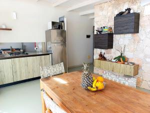 a kitchen with a wooden table with fruit on it at Boadream Ca' Madeira 1 Attico Linea Prestige in Sal Rei