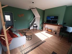 a living room with a couch and a fireplace at L'Ondine, single-family home in Abbeville