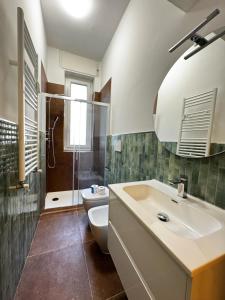 a bathroom with a sink and a toilet and a mirror at Kibilù - Via Ripamonti - Bocconi - Fondazione Prada - IEO in Milan