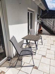 two chairs and a table on a patio at Ferienhaus Glücklich am Harz in Goslar +23 photos