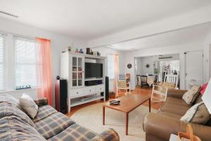 a living room with a couch and a table at Timeout - Lovingly renovated cottage close to Downtown! in Chincoteague