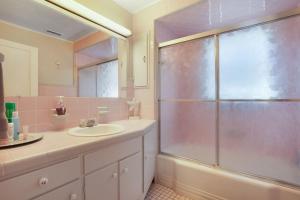 a bathroom with a sink and a shower at Timeout - Lovingly renovated cottage close to Downtown! in Chincoteague +28 photos