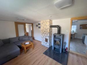 a living room with a couch and a fireplace at Ferienwohnung Sonnenblick in Sonneberg
