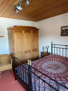 a bedroom with a bed and a wooden cabinet at Holiday home Gröbming Ski Mountains in Gröbming