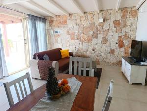 a living room with a table and a couch at Boadream Ca' Madeira 2 Attico Linea Prestige in Sal Rei