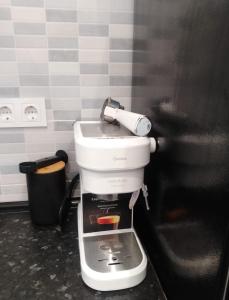a kitchen with a coffee maker on top of it at Beach Apartment in Puerto de Mazarrón