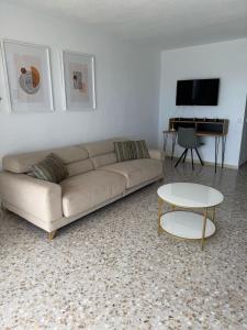 a living room with a couch and a table at Vista Villajoyosa in Villajoyosa