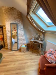 a living room with a window and a desk in a room at BENE A CASA Chambres d'hôtes in Veuzain-sur-Loire +64 photos