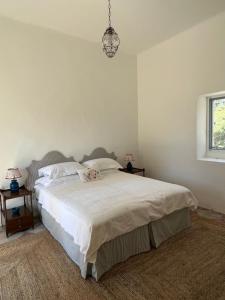 a bedroom with a bed with a dog laying on it at La Limonaia in Veglie +18 photos