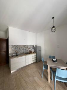 a kitchen with a table and a sink and a counter at Spinuzza relax in Cefalù +11 photos