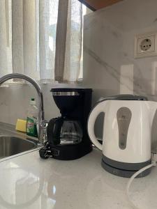 a coffee maker sitting on a counter next to a sink at Tile Apartments #5 in Agia Marina Nea Kydonias