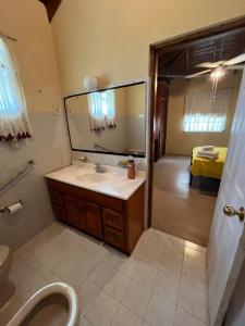 a bathroom with a sink and a mirror at GNC Guesthouse in Saint Peter +30 photos