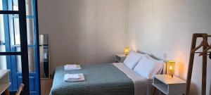 a bedroom with a bed with two lamps on it at Evdokia3 in Koufonisia