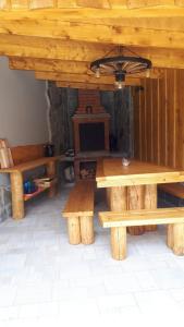 a dining room with wooden tables and a fireplace at Zrubový dom - Moon Nová Lesná in Nová Lesná