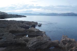 a view of a large body of water with rocks at Hostal Brisa Marina in Port d'Alcudia