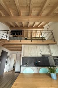 a loft kitchen with wooden ceilings and a balcony at La Clef des Franches in Saignelégier +21 photos