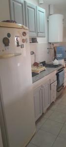 a kitchen with a white refrigerator in a kitchen at La posada de Lily in La Punta +21 photos
