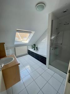 a bathroom with a shower and a sink and a tub at Lovely house next to Tomorrowland in Boom