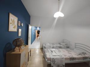 a bedroom with two twin beds and a hallway at HARBOR house in Kavála