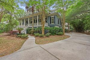 a large house with trees in front of it at 340 Low Oak Woods Road by Akers Ellis Rentals in Kiawah Island