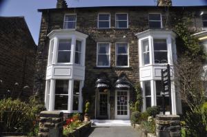 a large brick house with white windows at Arden House in Harrogate