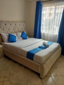 Postel nebo postele na pokoji v ubytování Sarafu Homes