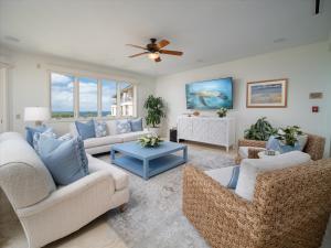 a living room with couches and a ceiling fan at Oceanviews, Fresh Upgrades At The Luxurious Grand Seascape K407!! in Wailea